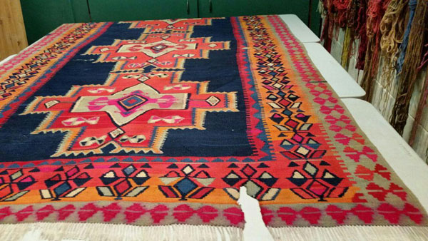 Rugs and kilims inside the Village Rug Repair workshop